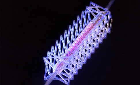 A 3D-printed hierarchical lattice glows lavender against a dark background