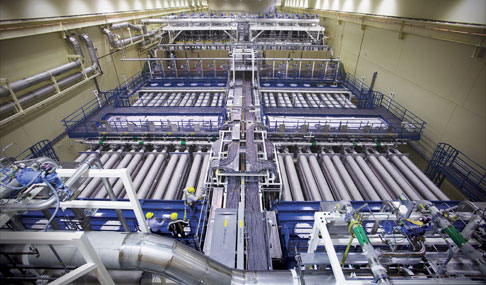 A photo of NIF’s laser bays from above, showing 48 beamlines flanking a central utility spine. 
