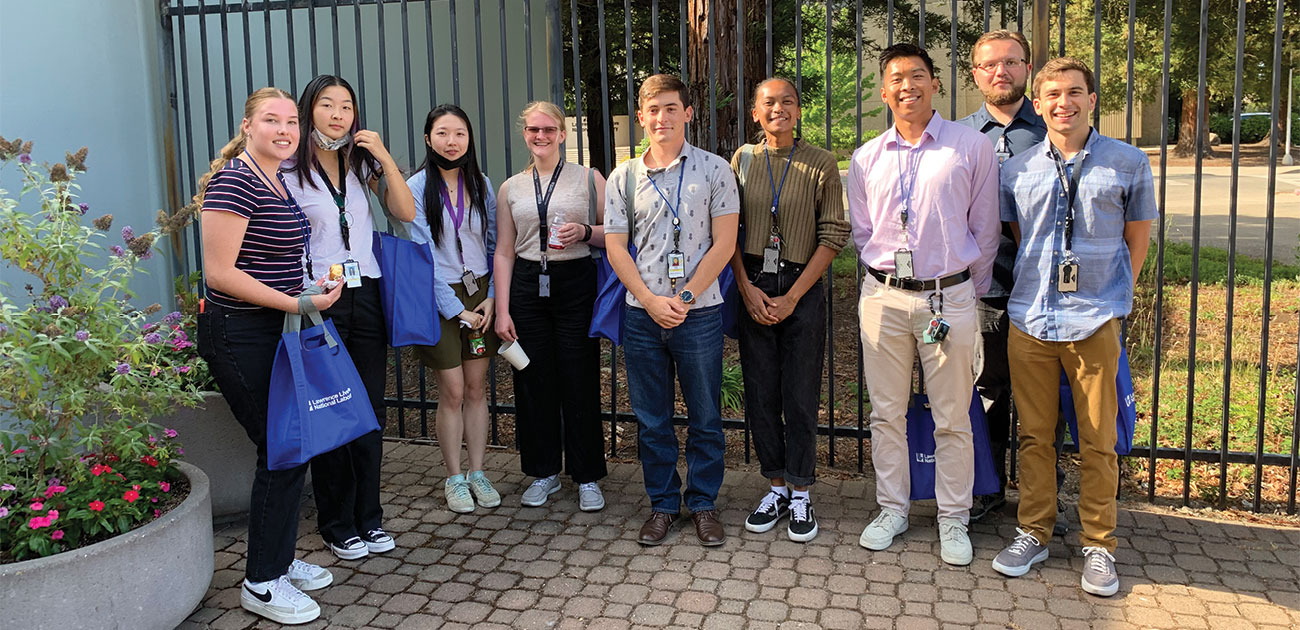 students standing in front of a gate