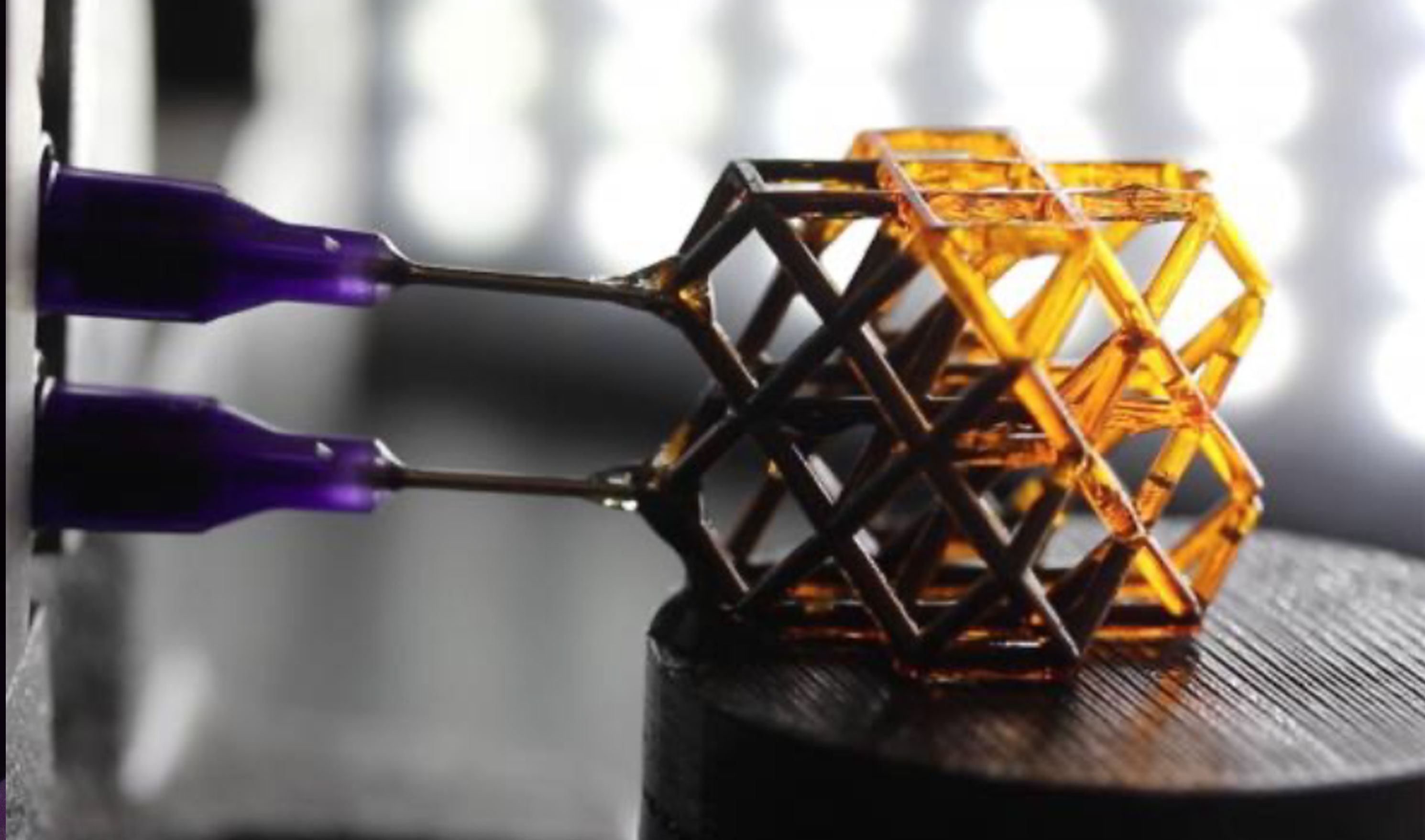 A 3D-printed hierarchical lattice glows lavender against a dark background